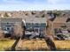 Backyard with deck and patio surrounded by mature trees, with neighboring houses nearby at 16135 Rock Crystal Dr, Parker, CO 80134