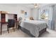 Bright bedroom featuring a large window with backyard view, desk, and ceiling fan at 16135 Rock Crystal Dr, Parker, CO 80134