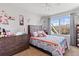 Charming bedroom with neutral walls, bright window, and a playful decor theme at 16135 Rock Crystal Dr, Parker, CO 80134