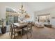 Open dining room with large windows, chandelier, and plenty of natural light at 16135 Rock Crystal Dr, Parker, CO 80134