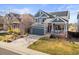 Two-story home featuring a covered front porch, attached two-car garage, and solar panels at 16135 Rock Crystal Dr, Parker, CO 80134