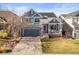 Charming two-story home with a welcoming front porch and well-manicured lawn at 16135 Rock Crystal Dr, Parker, CO 80134