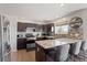 Modern kitchen featuring stainless steel appliances, granite countertops, tile backsplash and dark cabinets at 16135 Rock Crystal Dr, Parker, CO 80134