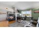 Office space including a desk and fireplace, with hardwood floors leading to the bedroom at 16135 Rock Crystal Dr, Parker, CO 80134