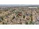 An aerial view shows a charming neighborhood with tree-lined streets and a home nestled among mature trees and landscaping at 2295 S Depew St, Denver, CO 80227