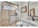 Modern bathroom with glass-enclosed shower, stone accents, and updated fixtures at 2295 S Depew St, Denver, CO 80227