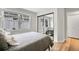 Bedroom with neutral walls, wood flooring, and large mirror sliding door closet at 2295 S Depew St, Denver, CO 80227