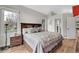Spacious bedroom with a large window, wood floors, and a stylish upholstered bed at 2295 S Depew St, Denver, CO 80227