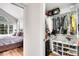Bright bedroom featuring a vaulted ceiling, large window, and attached organized closet at 2295 S Depew St, Denver, CO 80227
