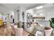 Dining area with a glass-top table, open to the kitchen, creating an inviting and functional living space at 2295 S Depew St, Denver, CO 80227