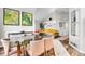 Open floor plan combining dining and living areas, featuring stylish decor, ample light, and hardwood floors at 2295 S Depew St, Denver, CO 80227