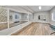 A spacious home gym features mirrors, wood floors, and a bright window for natural light during workouts at 2295 S Depew St, Denver, CO 80227