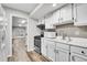 Bright kitchen featuring white cabinets, modern appliances, and access to the recreation area at 2295 S Depew St, Denver, CO 80227