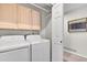 Laundry room with storage cabinets, washer and dryer at 2295 S Depew St, Denver, CO 80227