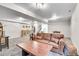 A basement living room offers a comfortable sofa, neutral carpet, and bright lighting, perfect for relaxation and entertainment at 2295 S Depew St, Denver, CO 80227
