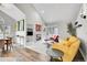 Open-concept living room with a white stone fireplace and comfortable seating at 2295 S Depew St, Denver, CO 80227