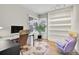 Bright office space featuring a large window, wood floors, and shelving at 2295 S Depew St, Denver, CO 80227
