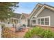 Cozy brick patio area with outdoor seating, barbecue, and covered porch at 2295 S Depew St, Denver, CO 80227