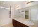 Bright bathroom with a double vanity, tiled floor, and a shower-tub combo at 5613 S Elk Ct, Aurora, CO 80016