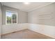 Bedroom with gray walls, white trim, and a large window at 5613 S Elk Ct, Aurora, CO 80016