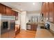 Modern kitchen with stainless steel appliances, wood cabinets, and an open layout at 5613 S Elk Ct, Aurora, CO 80016