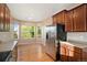 Well-lit kitchen featuring stainless steel appliances and hardwood floors at 5613 S Elk Ct, Aurora, CO 80016