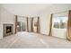 Bright living room with a cozy fireplace, sliding glass door, and ample natural light at 5613 S Elk Ct, Aurora, CO 80016