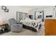 Bedroom with a double bed and a grey armchair at 3600 S Pierce St # 7-104, Denver, CO 80235