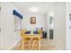 Bright dining area features a wooden table with four chairs at 3600 S Pierce St # 7-104, Denver, CO 80235