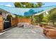 Outdoor space featuring a modern fire pit, lush green foliage, and a seating area for relaxation at 7307 S Birch St, Centennial, CO 80122