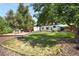 Spacious backyard features a playground, grass, mature trees and storage sheds at 7307 S Birch St, Centennial, CO 80122