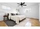 Cozy bedroom with a ceiling fan, plush bedding, two windows and wood flooring at 7307 S Birch St, Centennial, CO 80122