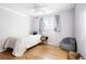 Well-lit bedroom boasting hardwood floors, a comfortable bed, and a gray beanbag at 7307 S Birch St, Centennial, CO 80122