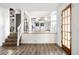 Open entryway with wood floors and a staircase leading up to the kitchen area at 7307 S Birch St, Centennial, CO 80122