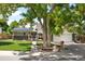 Home exterior featuring a green lawn, shade tree, and a charming brick and siding facade at 7307 S Birch St, Centennial, CO 80122