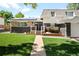 Charming home exterior featuring a well-maintained lawn, a brick facade and solar panels at 7307 S Birch St, Centennial, CO 80122