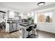 Kitchen with an island, stainless steel appliances, gray cabinets and wood floors at 7307 S Birch St, Centennial, CO 80122