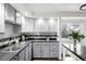 Kitchen featuring grey cabinets, modern backsplash and stainless sink at 7307 S Birch St, Centennial, CO 80122