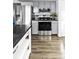 Kitchen with stainless steel appliances, grey cabinets, and a dark countertop at 7307 S Birch St, Centennial, CO 80122