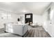 Cozy living room with a fireplace, a gray sofa and a white accent chair at 7307 S Birch St, Centennial, CO 80122