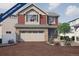 Under Construction: Charming two-story home with a brick driveway, stone accents, a two-car garage and blossoming landscaping at 1170 Sugarloaf Ln, Erie, CO 80516