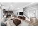 Bright open-concept living room features recessed lighting, a modern staircase and stylish decor, seamlessly connecting to the kitchen at 1170 Sugarloaf Ln, Erie, CO 80516