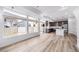 Open floor plan showcasing the kitchen, living room, large windows, and hardwood flooring at 1170 Sugarloaf Ln, Erie, CO 80516