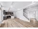 Spacious living area with hardwood floors and an open floor plan that connects the living and kitchen area at 1170 Sugarloaf Ln, Erie, CO 80516