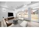 Modern living room featuring large windows, light-colored flooring, a sofa, and contemporary decor at 1170 Sugarloaf Ln, Erie, CO 80516