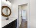 A bathroom with white cabinets, dark hardware, and a decorative mirror at 339 Rocking Chair Dr, Berthoud, CO 80513