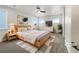 Bright bedroom featuring a ceiling fan, modern decor, soft rug, and minimalist bedside tables at 339 Rocking Chair Dr, Berthoud, CO 80513