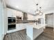 Modern kitchen with stainless steel appliances, a center island, and stylish backsplash at 339 Rocking Chair Dr, Berthoud, CO 80513