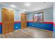 Basement room with a red and blue accent stripe at 9983 Cottoncreek Dr, Highlands Ranch, CO 80130