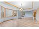 Bright dining room with large windows, tray ceiling, and chandelier adjacent to the living area at 9983 Cottoncreek Dr, Highlands Ranch, CO 80130
